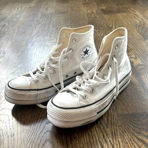 High top converse tennis shoes.